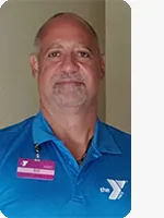 headshot of male personal trainer wearing blue YMCA polo with white Y logo and purple name tag