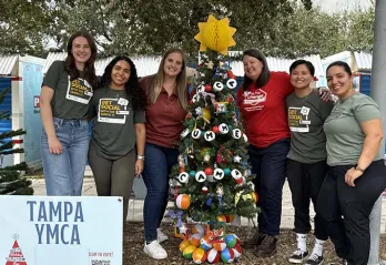 YMCA Association Office Staff in Curtis Hixon by our Holiday Tree.