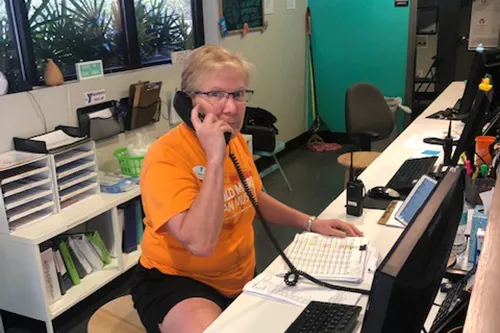 YMCA staff member on the phone at welcome center