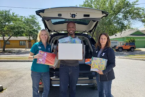 Tampa Y admin staff with Hillsborough Education Foundation staff holding school supplies