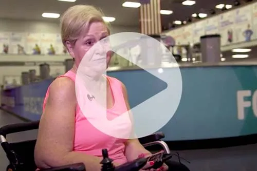 woman in wheel chair with play button over image