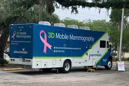 AdventHealth Mammography bus at YMCA parking lot under a tree