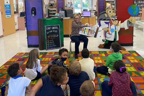 after school students listening to reading of a very hungry caterpillar