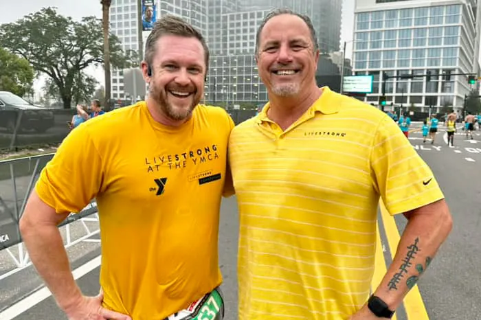 Two men wearing yellow shirts at the 2022 Tampa YMCA Turkey Gobble race.