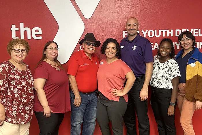 6 YMCA employees stand together, 3 from Puerto Rico on the left. 3 Tampa YMCA employees are on the right