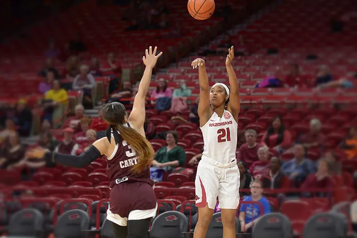 Devin Cosper playing basketball for Arkansas.