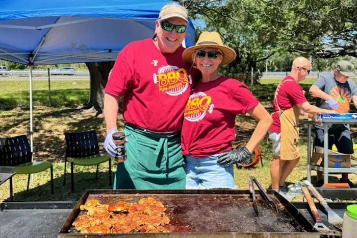 Volunteers cooking food at the South Tampa BBQ Fundraiser.