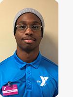 headshot of male personal trainer wearing blue YMCA polo beige background