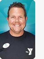 headshot of male personal trainer wearing black YMCA shirt teal background