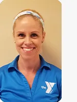 headshot of female personal trainer wearing blue YMCA polo beige background