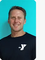 headshot of male personal trainer wearing black YMCA shirt teal background