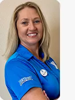 headshot of female personal trainer wearing blue YMCA polo beige background