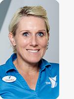 headshot of female trainer wearing blue YMCA polo gray background