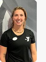 headshot of female personal trainer wearing black YMCA shirt gray background