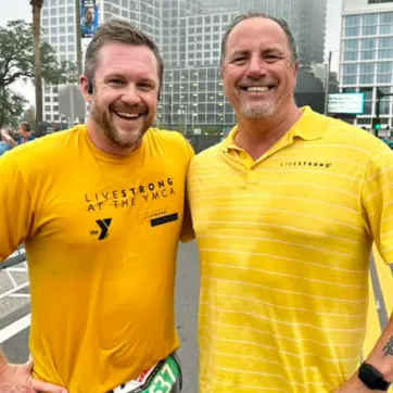Two men wearing yellow shirts at the 2022 Tampa YMCA Turkey Gobble race.