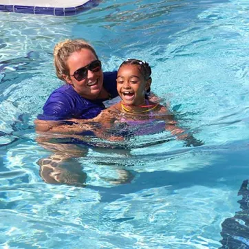 Morgan works with a younger swimmer on her strokes.