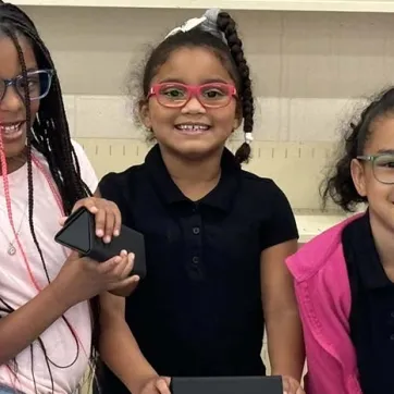 Promiyse Quick (first from left) and her friends loved their new eye glasses.