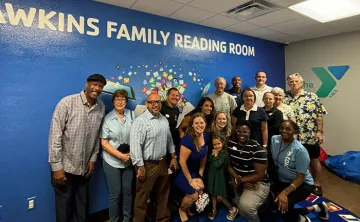 Carl and Cynthia Hawkins (middle) at the ribbon-cutting event with Bob Sierra Y staff and board members
